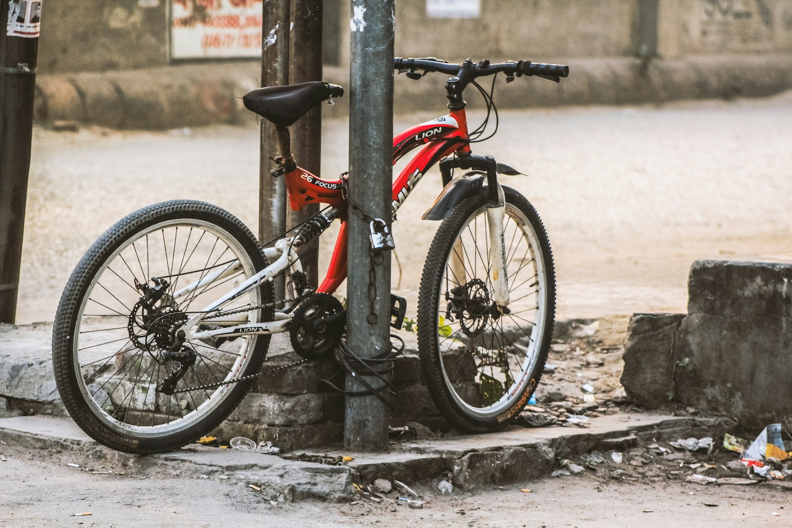 a bicycle is chained up to a pole